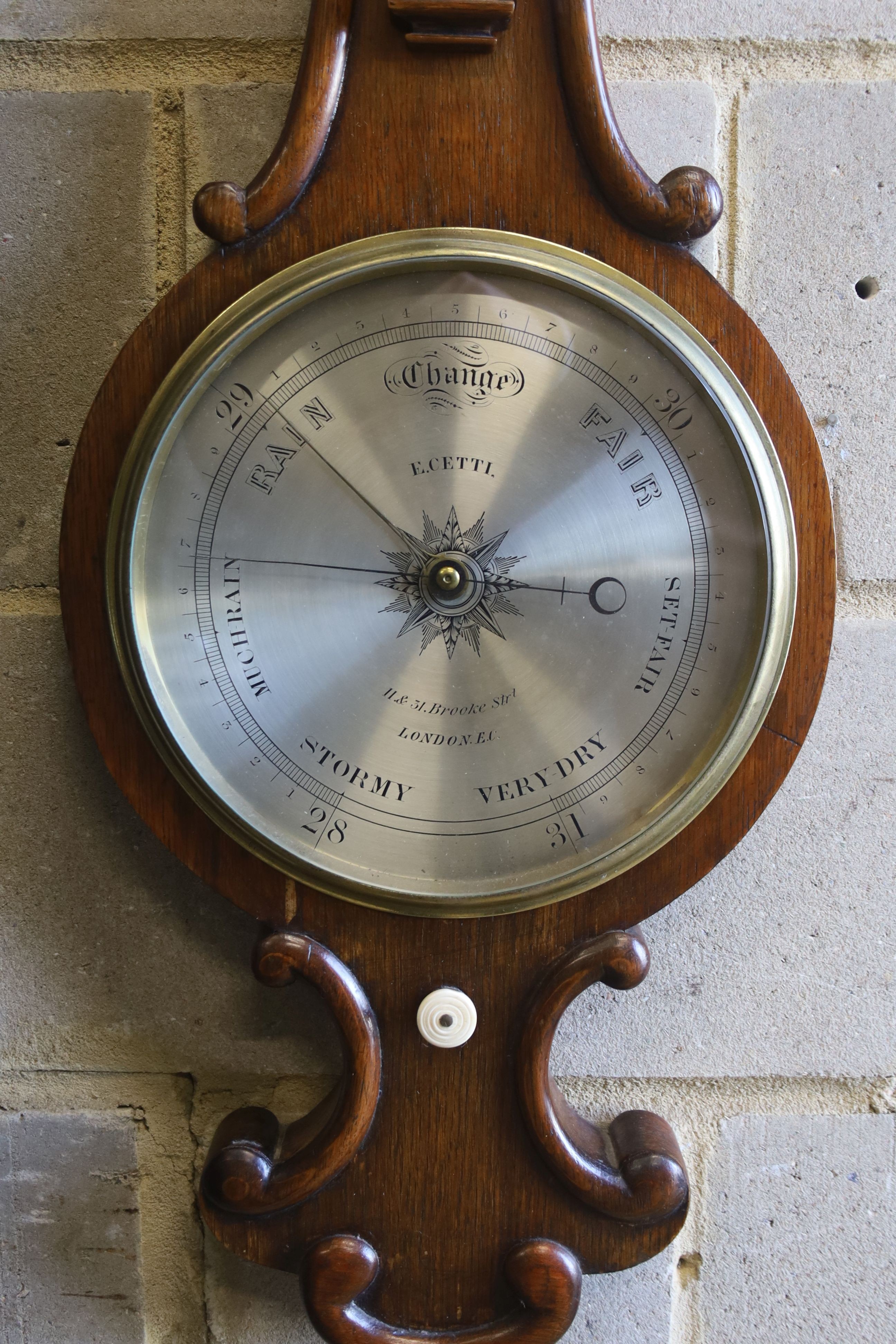 A Victorian oak cased wheel barometer and thermometer by E. Setti, Brooke Street, London, height 102cm